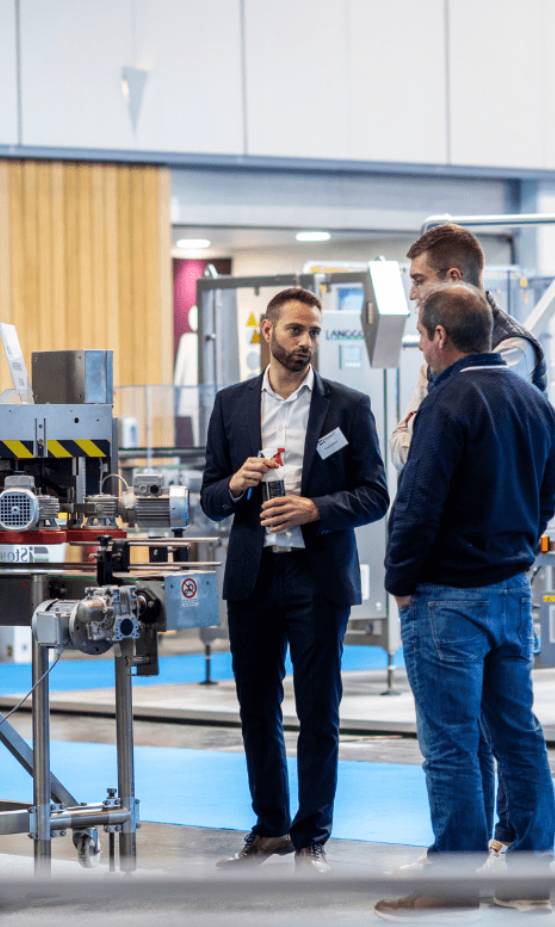 People talking in front of a machine