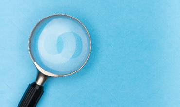 A magnifying glass on a blue background