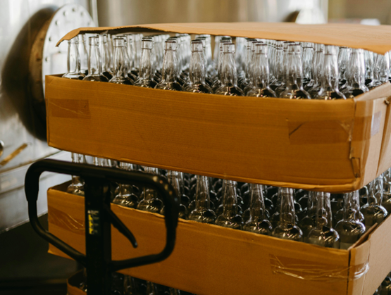 Pallet of glass bottles in a cardboard box, ready for the production line