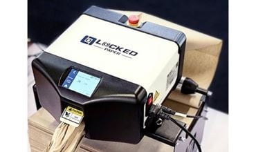 Compact industrial machine branded Locked Paper, featuring a control screen and emergency stop button, converting paper into protective packaging material.