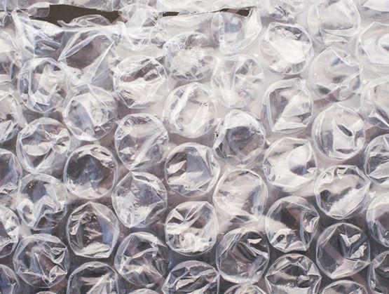 Close-up of transparent bubble wrap showing the texture of air-filled bubbles used to protect items during packaging.