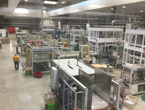 Interior view of an industrial production workshop equipped with numerous automated machines and manufacturing lines.