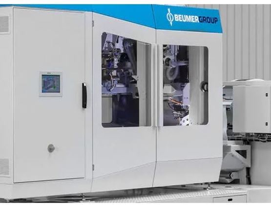 BEUMER Group industrial machine used for automated packaging, with glass panels and a control screen.