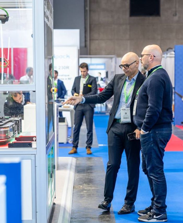 2 people watching a machine